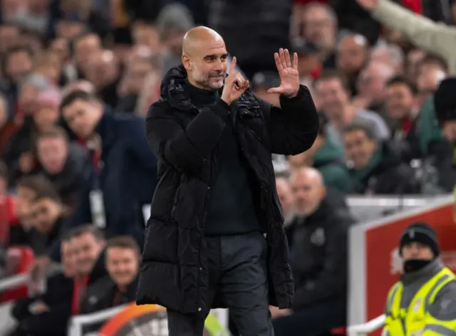 Manchester City manager Pep Guardiola holds up six fingers to indicate the six premier league titles he has won