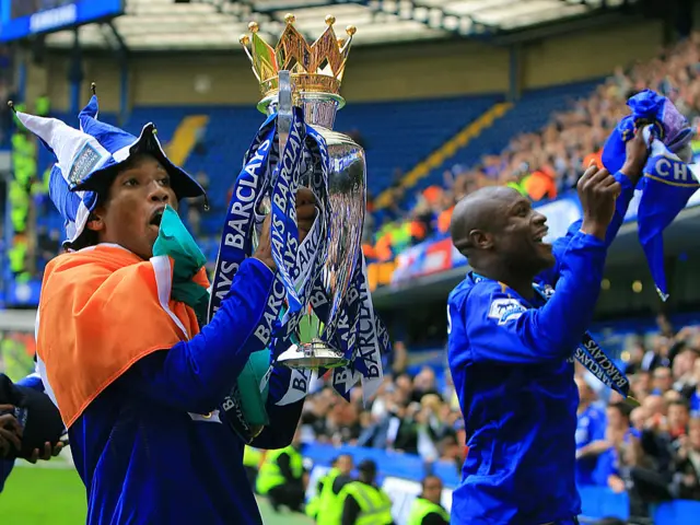 Chelsea players Didier Drogba (L) and William Gallas celebrate with the Premiership trophy