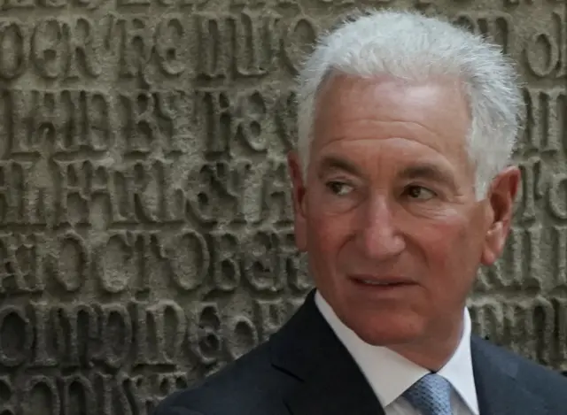 Charles Kushner in a suit looking away from the camera