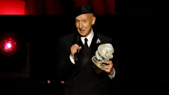 Stephen Jones accepts the British Accessories Designer Award on stage during The Fashion Awards 2024 presented by Pandora at Royal Albert Hall on December 02, 2024 in London, England