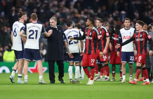 Tottenham Hotspur manager Ange Postecoglou shakes hands with Dejan Kulusevski