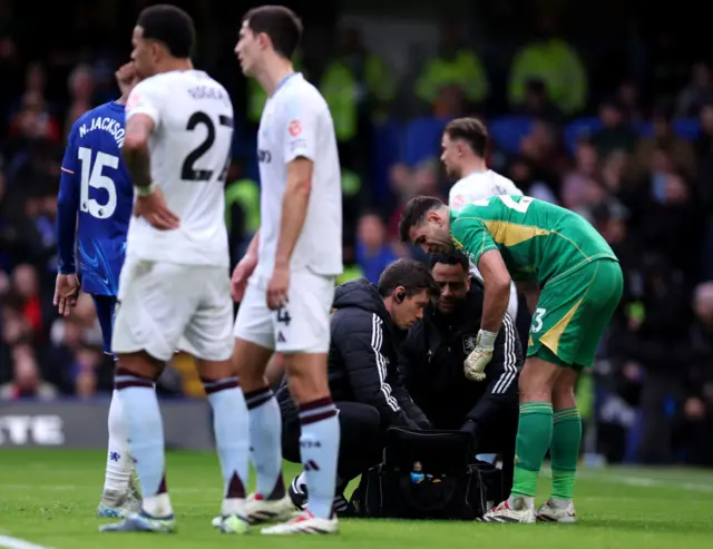 Emi Martinez receives treatment on a hand injury