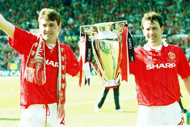 Steve Bruce and Bryan Robson celebrate with the premiership trophy