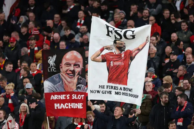 Fans of Liverpool are seen with banners in support of Arne Slot, Manager of Liverpool, and Mohamed Salah of Liverpool