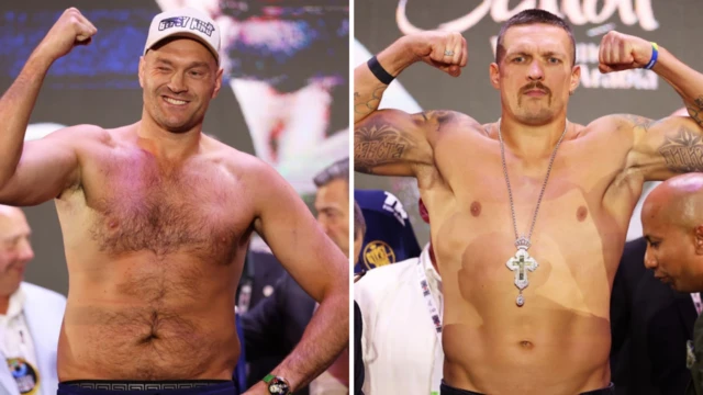 Tyson Fury holds up his fist and Oleksandr Usyk holds up both arms