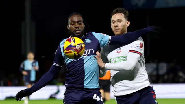 Bolton's Gethin Jones challenges Wycombe's Fred Onyedinma