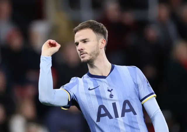 Tottenham midfielder James Maddison doing his darts celebration.