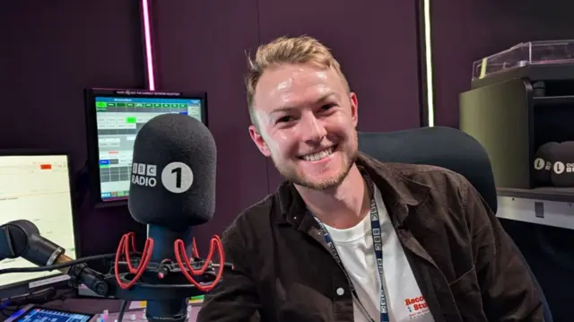 A man next to a BBC microphone