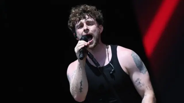 Tom Grennan performing on stage