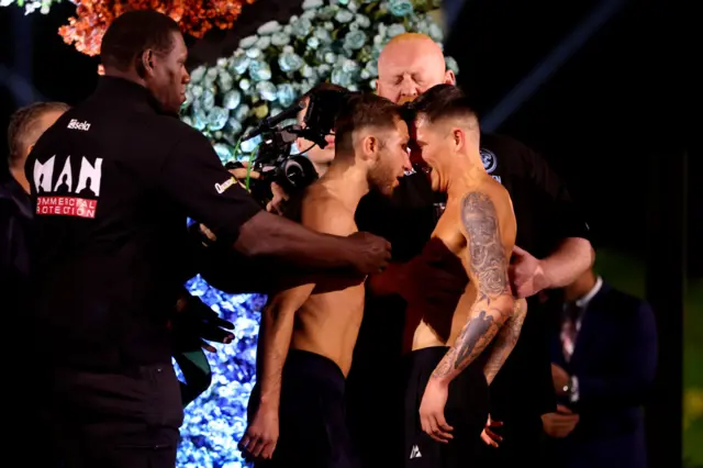 Isaac Lowe puts his head to Lee McGregor at a weigh-in