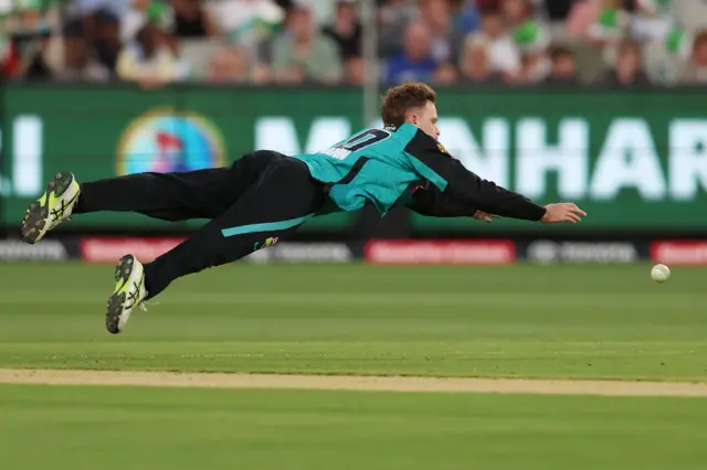 Matt Kuhnemann of the Heat dives for the ball during the BBL match between Melbourne Stars and Brisbane Heat