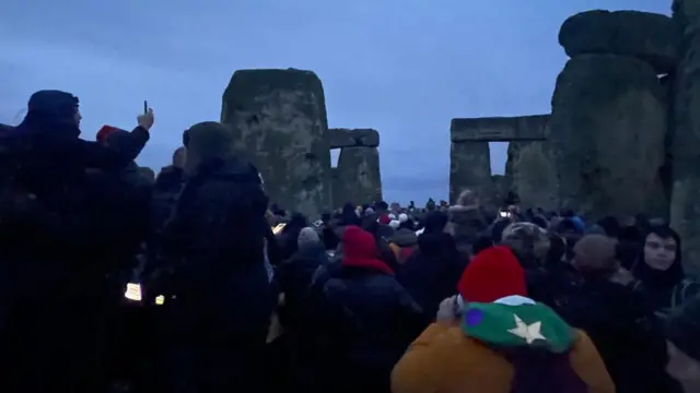 People gather at stonehenge to watch the sunrise on the winter solstice