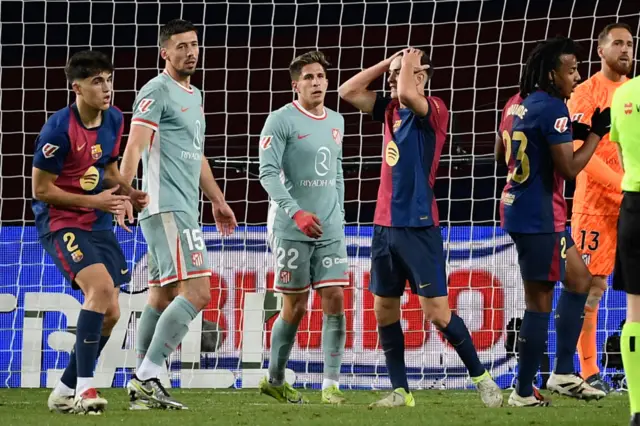 Barcelona's Spanish midfielder #06 Pablo Gavi (C) reacts after missing a chance