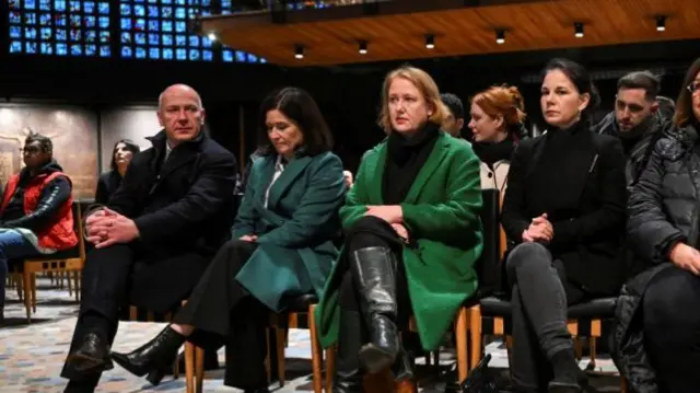 Berlin's governing mayor Kai Wegner, his partner, German Family Minister Lisa Paus and German Foreign Minister Annalena Baerbock all seated at a memorial service