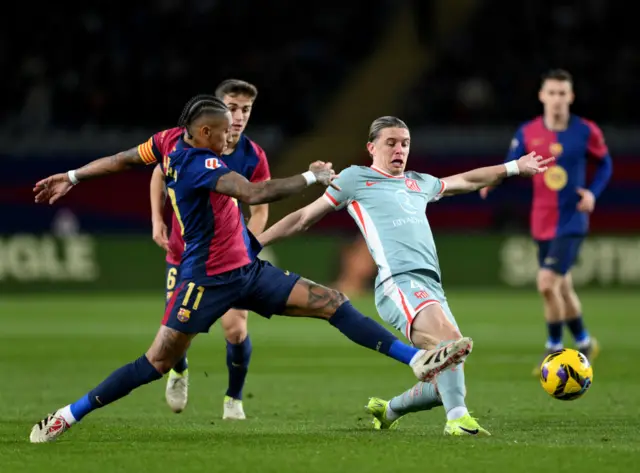 Raphinha of FC Barcelona and Conor Gallagher of Atletico de Madrid battle for possession during the LaLiga match