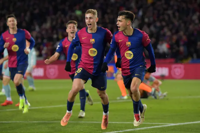 Barcelona's Spanish midfielder #08 Pedri (R) celebrates scoring their first goal