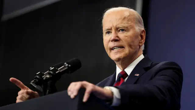 President Joe Biden speaking at a lectern and pointing his finger