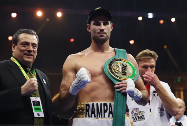 Andrii Novytskyi celebrates victory with his belt following the WBC International Heavyweight title