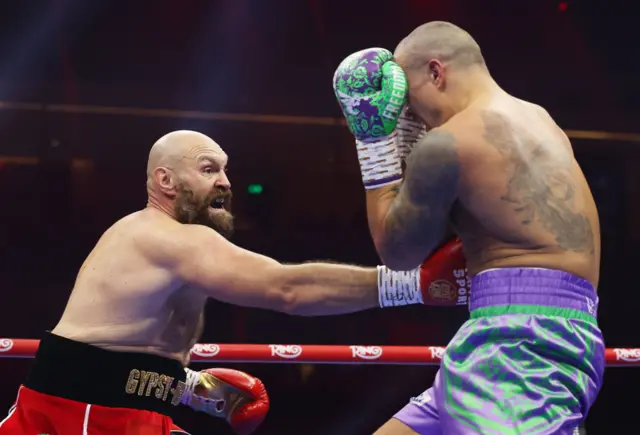 Tyson Fury with a body punch on Oleksandr Usyk