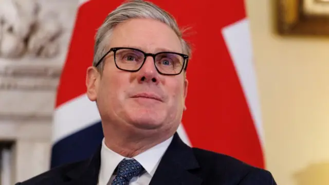 Headshot of Keir Starmer taken from slightly below as he looks off to the side