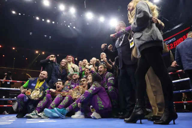 Team Usyk having a picture in the ring