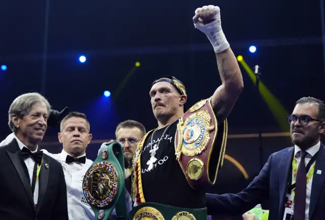 Oleksandr Usyk with his world titles celebrating