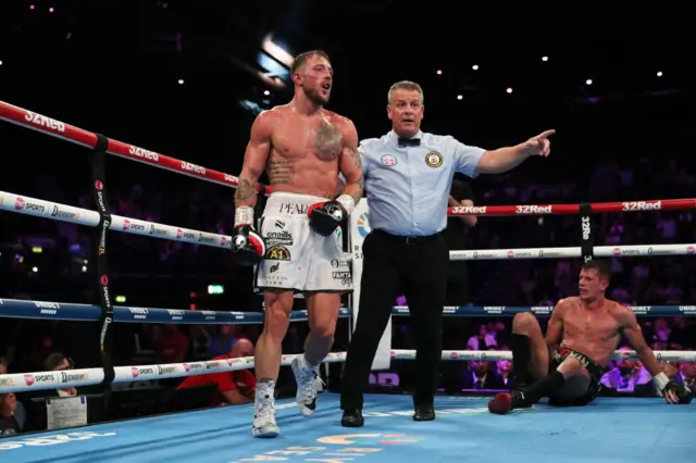 Referee Michael Alexander sends Brad Pauls to his corner having knocked down Nathan Heaney