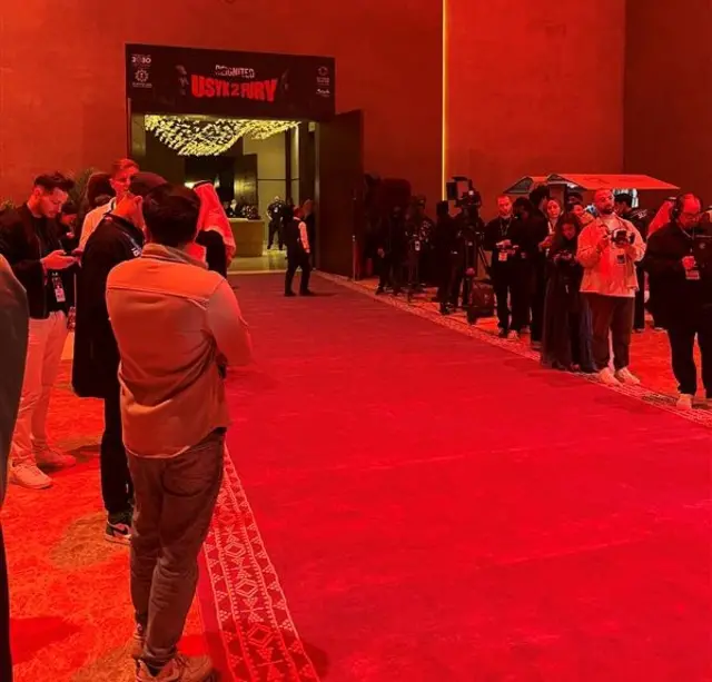 People stood next to a long carpet