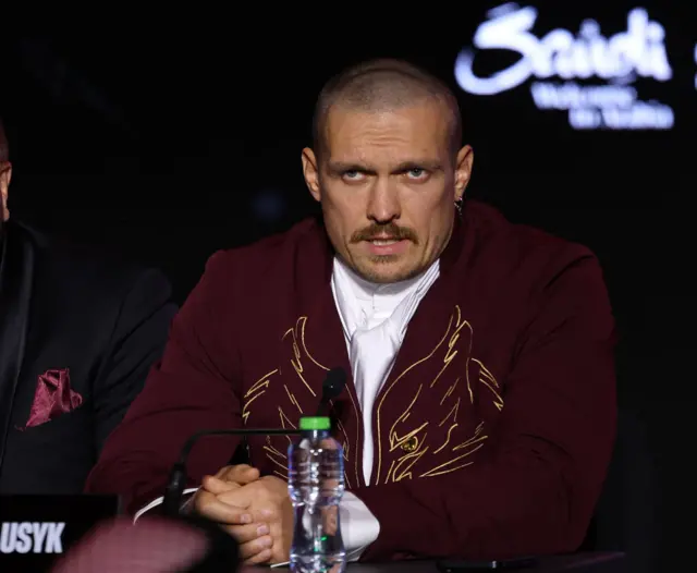 Oleksandr Usyk wearing a maroon suit