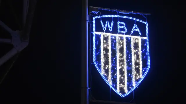 A West Bromwich Albion sign is lit up in the dark