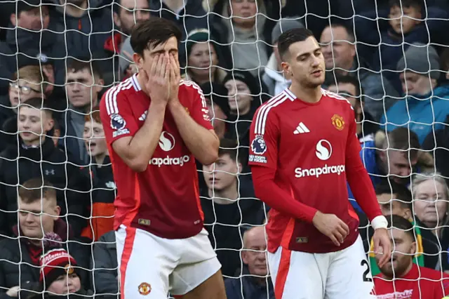 Harry Maguire and Manchester United's Portuguese defender Diogo Dalot react