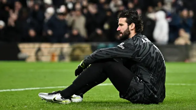 Liverpool's Alisson Becker looks dejected