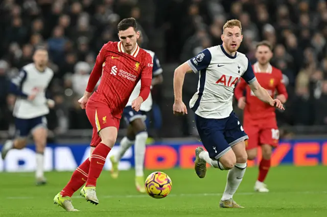 Andrew Robertson (L) crosses the ball