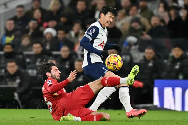 Dominik Szoboszlai (L) fights for the ball with Son