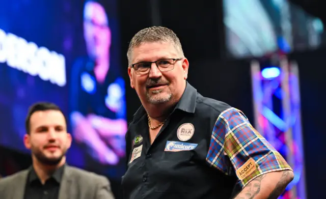 Gary Anderson looks on