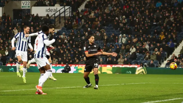 Mikey Johnston heads the ball into the net