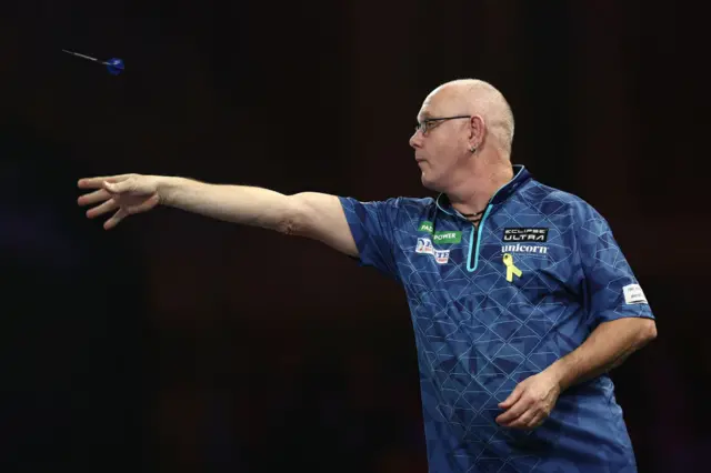 Ian White throws a dart