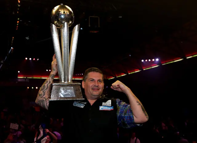 Gary Anderson holds the 2015 PDC World Darts Championship trophy