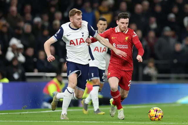 Andrew Robertson of Liverpool holds off a challenge from Dejan Kulusevski