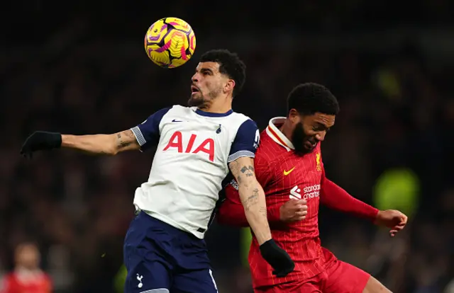 Pape Matar Sarr of Tottenham Hotspur controls the ball under pressure from Joe Gomez