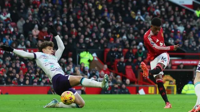 AFC Bournemouth's Milos Kerkez in action as Manchester United's Amad Diallo shoots at goal