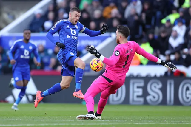 Jamie Vardy of Leicester City is challenged by Jose Sa