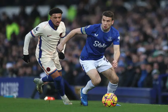 Seamus Coleman of Everton runs with the ball whilst under pressure from Jadon Sancho