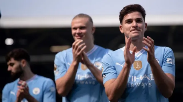 Erling Haaland and Julian Alvarez applaud the Manchester City fans during the end of the 2023-24 season