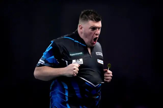 Daryl Gurney celebrates beating Florian Hempel