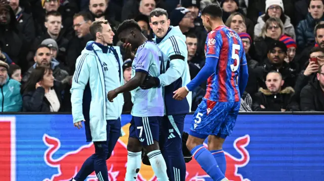 Arsenal's Bukayo Saka is helped from the field after coming off injured against Crystal Palace