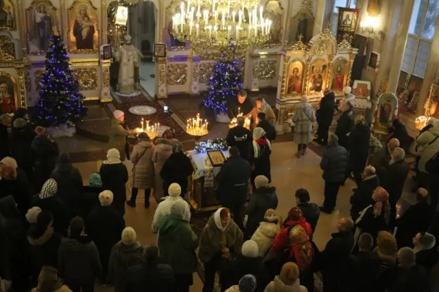 People during a Christmas service in a church in Odesa