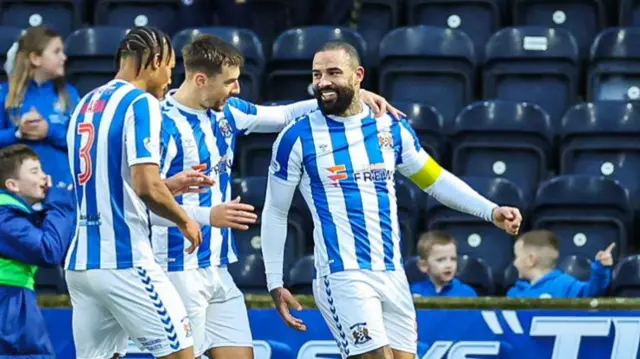 KILMARNOCK, SCOTLAND - DECEMBER 26: Kilmarnock's Kyle Vassell (R) celebrates scoring to make it 1-0 with teammates Corrie Ndaba (L) and Brad Lyons during a William Hill Premiership match between Kilmarnock and Aberdeen at Rugby Park, on December 26, 2024, in Kilmarnock, Scotland. (Photo by Roddy Scott / SNS Group)