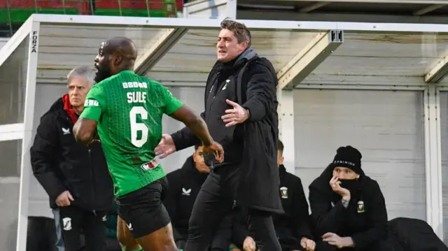 Glentoran boss Declan Devine watches on