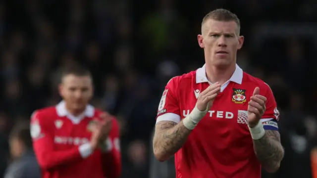 Wrexham captain James McClean applauding fans